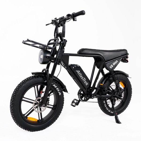 Black AtlasTrek V8 Max electric fat bike shown from the front three-quarter angle with round headlight, front cargo rack, long padded seat, rear suspension and 20 by 4 inch Kenda fat tires