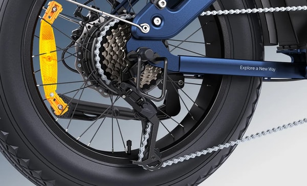Close-up of the Shimano rear derailleur, cassette, chain and disc rotor on the blue Engwe Engine Pro 3.0 Boost folding fat bike with orange spoke reflectors