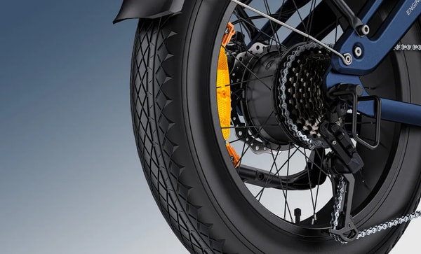 Close-up of the rear hub motor, cassette and derailleur on the blue Engwe Engine Pro 3.0 Boost electric fat bike with an orange spoke reflector and fat tire